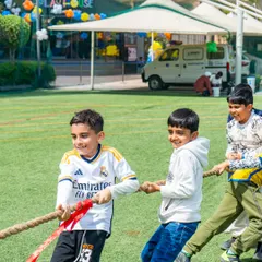 It's all about teamwork and fun. A classic game of tug-of-war on the outdoor field gets all the kids pulling together and laughing.