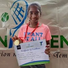 This is what success looks like. A participant from our Orange Ball group proudly holds her medal and certificate after a great performance.