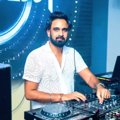 Here I am in my element, focused on the mix with my Pioneer DJ console. A great party is all about seamless transitions and the right track at the right moment, and I use professional gear to deliver just that.