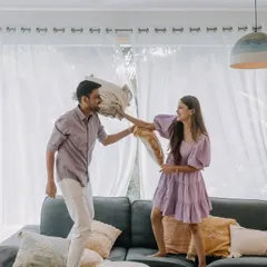 Our shoots are about being yourselves and having fun. We encourage playful, unscripted moments like this spontaneous pillow fight during a cozy indoor session in Goa, capturing the genuine laughter and joy that defines your relationship.
