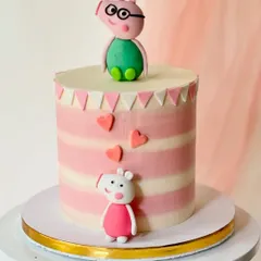 A clean and modern Peppa Pig cake with Daddy Pig and Peppa figures. The pink striped buttercream and little hearts create a simple yet charming design for a young fan's celebration.