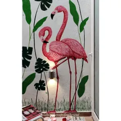 This detail shot captures the pair of flamingos. The way they interact adds a narrative element to the vibrant, nature-filled scene.