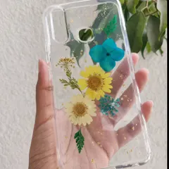 A custom phone case made with real dried flowers. I arranged these yellow and blue daisies and added a sprinkle of gold leaf to create a beautiful, botanical design.