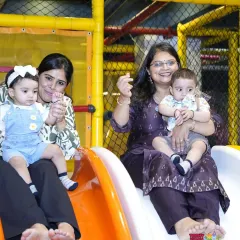 It's fun for parents too. Here are two moms having a great time going down the slide with their toddlers, sharing a laugh and making a happy memory together.