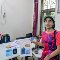 It's wonderful to see students proud of their progress. Here's a student showing her finished watercolor painting from an object study class, where she learned to capture the transparency and reflection of glass and water.