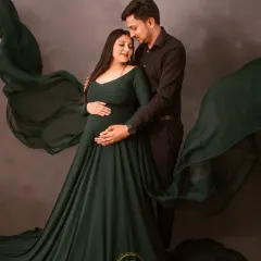 This is an example of my dramatic maternity photography. The deep green flowing gown and moody, textured background create a powerful, fine-art portrait for this expecting couple.