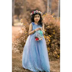 Kids' photoshoots aren't just for toddlers. Here, seven-year-old Brishka looks like a fairytale princess in her beautiful blue gown, complete with a floral crown and whimsical birdcage prop for her birthday portraits.