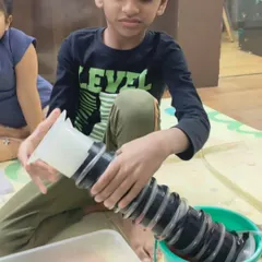 This is what meaningful STEM learning looks like. A young boy is deeply focused on an engineering activity, learning problem-solving skills through hands-on exploration.