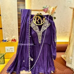 A royal purple suit set, elegantly draped and ready for gifting. I use custom hangers and stands to ensure the outfit's shape and embroidery are perfectly showcased as part of the wedding trousseau.