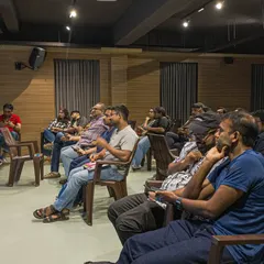 An audience listening during a weekend event. Our performance space is designed to be intimate, fostering a close connection between the speaker and the listeners.