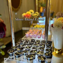 I offer a wide selection of single-serving desserts, perfect for guests to enjoy. This display shows delicious chocolate mousse cups neatly arranged on an illuminated, multi-tiered stand.