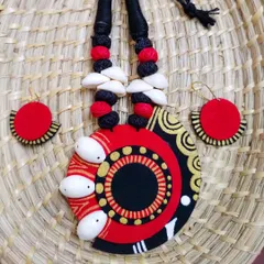This statement necklace set is a perfect example of my craft. It combines hand-painted fabric in bold red and black with intricate patterns and is embellished with natural cowrie shells for a distinct tribal-boho feel. The matching earrings complete this lightweight, wearable art piece.
