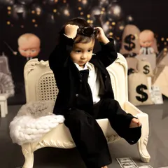 A candid moment from a 'Boss Baby' themed shoot. Even with all the props, my goal is to capture the natural expressions and playful attitude of your child.
