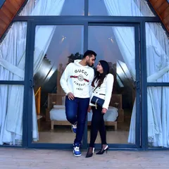 A stylish pre-wedding couple shoot set against a modern A-frame cabin. This image captures a genuine, intimate moment and demonstrates our skill in creating lifestyle portraits for couples in unique locations.