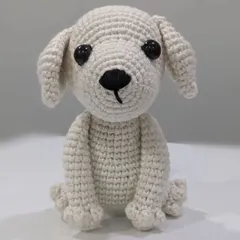 A handmade amigurumi dog named Milky, sitting patiently. This is a simple yet charming representation of a white puppy.