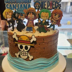 Set sail on a sweet adventure with this One Piece anime cake. The design features a chocolate "barrel" tier, blue buttercream waves, and the Straw Hat Pirates crew, ready for a pirate-themed party.