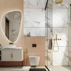 This luxurious bathroom design pairs large-format marble-style tiles with soft pink fluted panels. The organic-shaped backlit mirror and gold fixtures add a final touch of elegance.