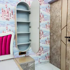 This wall-mounted dressing unit features a rotating oval mirror that opens to reveal multiple shelves. It's a perfect solution for adding storage and function to a bedroom without taking up floor space.