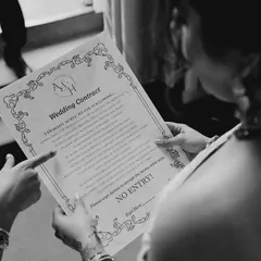 A playful "wedding contract" for guests to sign before entry. It's these fun, interactive details that make a wedding truly memorable and full of personality.