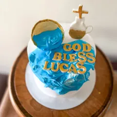 A top-down view of the whipped cream design, showing the fondant chalice and cross.