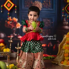 Celebrating tradition is at the heart of what I do. This portrait captures a little one dressed in a beautiful Pattu Langa for a traditional ceremony shoot. The backdrop is rich with cultural elements like marigolds and mango leaves, creating a vibrant and authentic festive atmosphere.