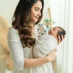 The serenity of a mother holding her newborn for the first time is a moment of pure grace. I aim to capture this profound bond in a soft, gentle, and timeless way during my newborn photography sessions.