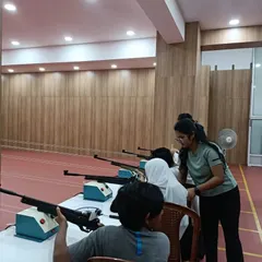 Safety and proper technique are the first things we teach. Here, one of our certified coaches is instructing a group of new shooters, ensuring everyone understands the fundamentals before they take their first shot.