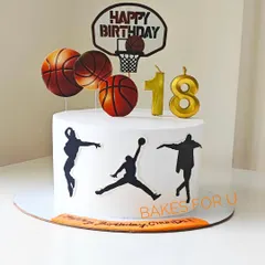 An 18th birthday cake for a basketball fan, decorated with player silhouettes, basketballs, and a hoop topper. It's a slam dunk for any sports-themed party.