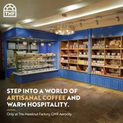 Step into a world of artisanal coffee and warm hospitality at The Hazelnut Factory. The image shows a beautiful patisserie counter filled with tempting treats and a welcoming ambiance.