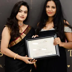 Receiving my professional makeup artist certificate from my mentor, Lakshmi Shetty. Her academy is where I built my foundational skills.