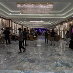 This is the spacious and luxurious Sky Banquet hall in Kharghar, which features a stunning marble floor and a grand crystal chandelier. It's a premium venue with a separate dining area that can host up to 700 guests.