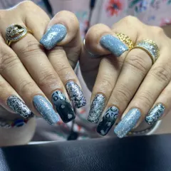 A bold set of long, square extensions featuring a mix of textures. The design combines light blue glitter, chunky silver glitter, and a black-to-blue ombre with a leopard print accent.