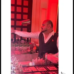 Our founder, Sid, is a master of flair bartending. This shot captures him mid-throw, showcasing the skill and showmanship that we bring to events to entertain your guests.