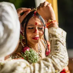 The sacred sindoor moment. This powerful close-up captures one of the most significant rituals of a Hindu wedding, symbolizing the bride's new journey as a married woman.