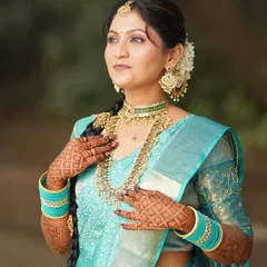 A classic portrait showcasing the full splendor of the South Indian bridal look, from the intricate jewelry to the beautifully draped saree.