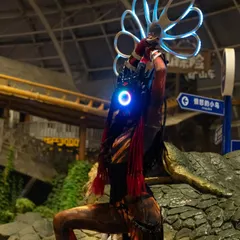 A different pose from our Alien LED show, highlighting the intricate details of the costume and the glowing props against a themed backdrop.
