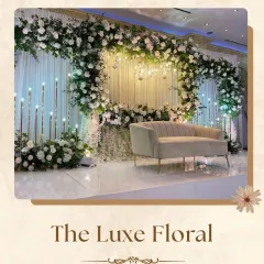 For a look of pure "Luxe Floral" elegance, I designed this stage with a grand arch of white roses and greenery. The clean lines, modern sofa, and soft lighting from candle-like fixtures create a sophisticated and timeless atmosphere.