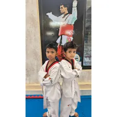 Two of our little champs striking a confident pose. We focus on building self-esteem and a positive attitude from day one.