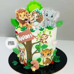 A sweet jungle cake for Maarini's 3rd birthday. This design features cute, cartoonish animal friends like a lion, elephant, and leopard, gathered around a tree in a friendly forest setting.