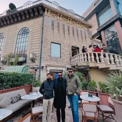 With friends outside a classic European-style building. As the saying goes, a lawyer's time and advice are his most valuable assets.
