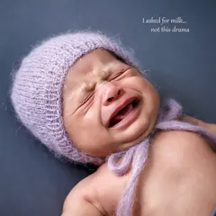 Even a little cry can make for a memorable photo. We believe in capturing the full range of newborn emotions, and this expressive moment is both real and endearing.