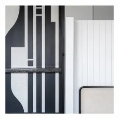 A detail shot from our Powai House project, showcasing the interplay of textures and patterns. The bold, graphic black-and-white design contrasts with the simple, clean lines of the white paneled wall, highlighting our focus on corners and details.