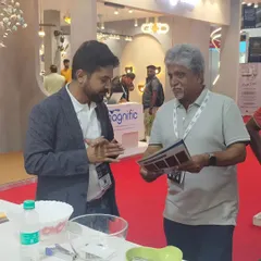 Here I am discussing the technical specifications and design options for our automation solutions with a visitor at our exhibition booth. I believe in taking the time to understand each client's unique needs.