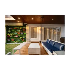Another view of the balcony with the vibrant vertical garden. This angle shows the comfortable seating arrangement, perfect for enjoying a calm, cozy moment at any time of day.