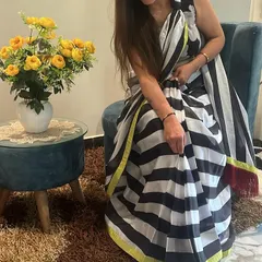 A seated pose in the black and white striped saree. It’s a versatile piece that looks effortlessly chic.