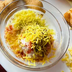 My Dahi Vada is known for being super soft and juicy. It's a classic chaat item that I always recommend, topped with fresh sev for that perfect crunch.