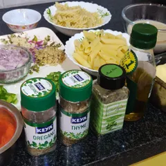 The fresh ingredients I use for my pasta dishes, including penne, fusilli, herbs like oregano and thyme, and quality olive oil.