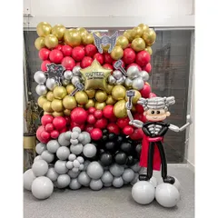 To make this Thor-themed party even more epic, we added a custom-made, life-size Thor balloon sculpture. This character stands ready for photos in front of the thunderous red, gold, and silver balloon wall.