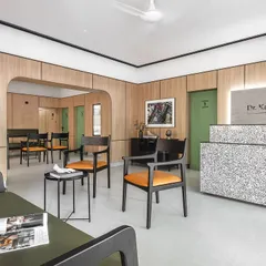 The reception and waiting area of Dr. Banerjee's Homeopathy Clinic. We used a minimalist approach with warm oak panels, a monolithic quartz desk, and clean lines to create a tranquil space that immediately puts patients at ease.