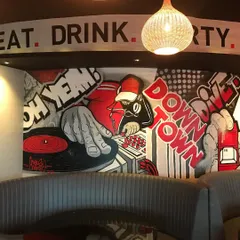 I brought a pop-art, comic book vibe to this downtown restobar. This mural section features a DJ spinning vinyl, setting the energetic tone for the whole space with bold red and black graphics. It’s all about creating an atmosphere that makes people want to stay.